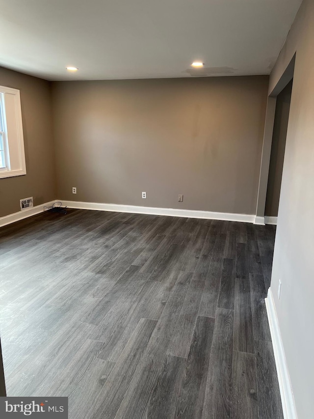 spare room featuring dark hardwood / wood-style flooring