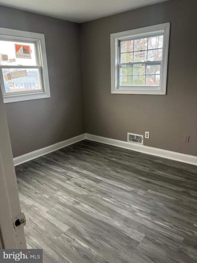 empty room featuring dark wood-type flooring