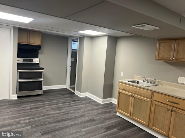 kitchen featuring a paneled ceiling, dark hardwood / wood-style floors, sink, and stainless steel range with electric cooktop