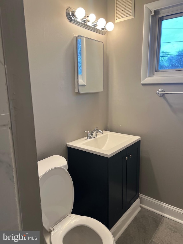 bathroom with tile patterned flooring, vanity, and toilet