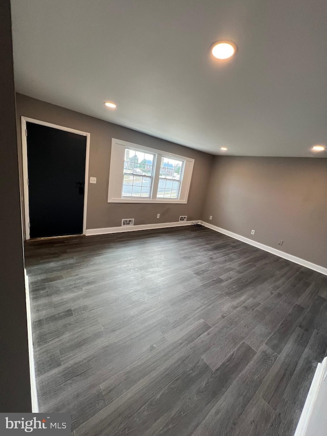 spare room with dark wood-type flooring