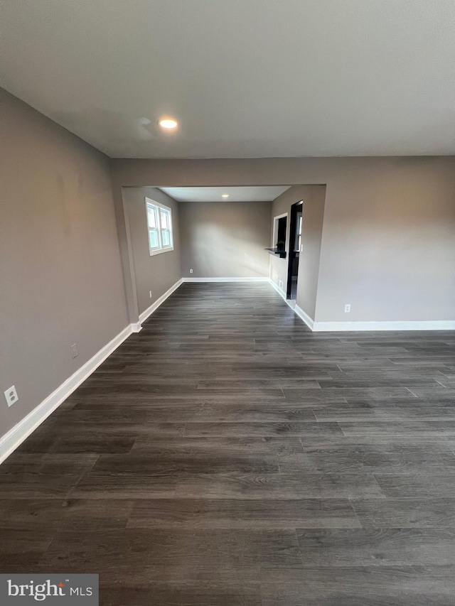 spare room featuring dark wood-type flooring