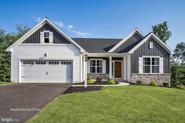 view of front of home with a front yard and a garage