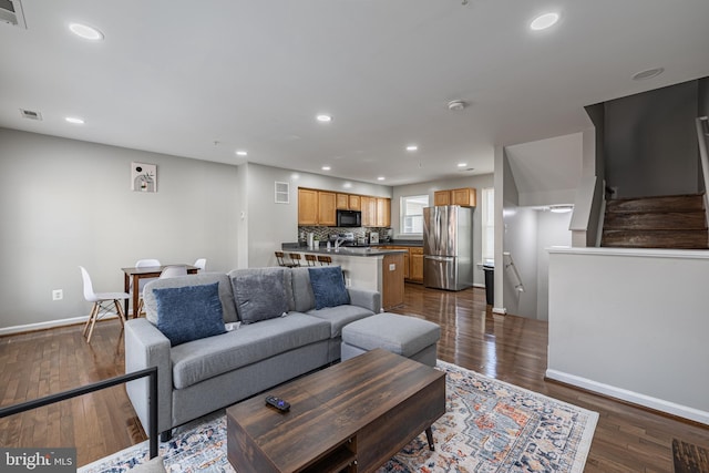 living room with dark hardwood / wood-style floors