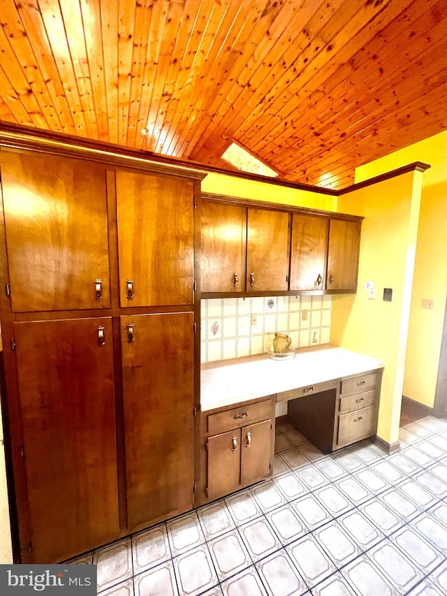 kitchen with built in desk and wooden ceiling