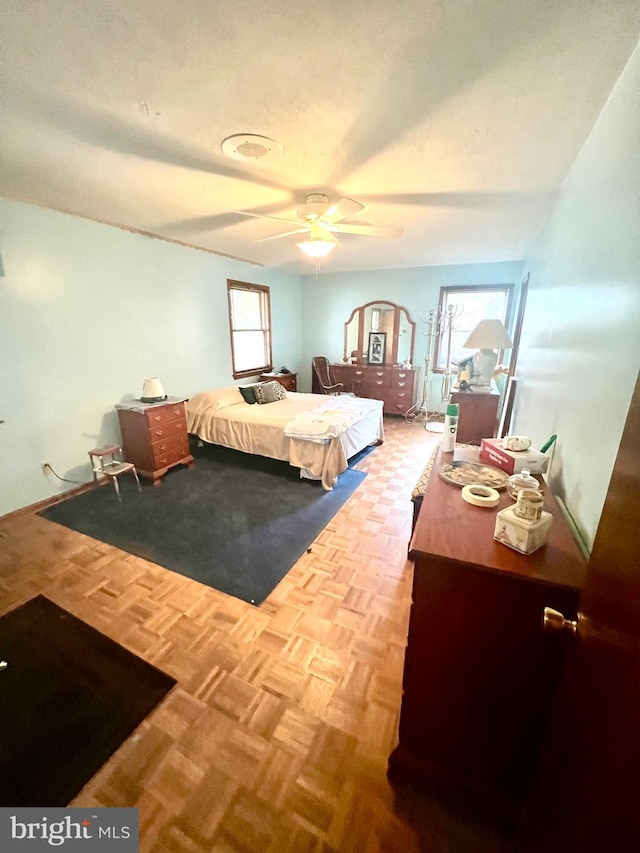 bedroom with ceiling fan and parquet floors