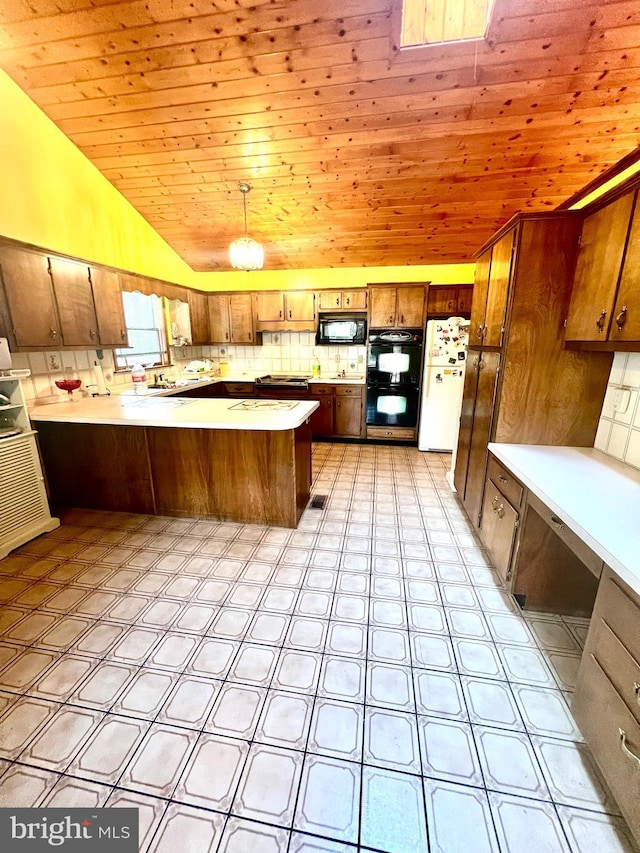 kitchen with wooden ceiling, tasteful backsplash, kitchen peninsula, pendant lighting, and black appliances