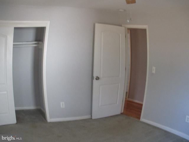 unfurnished bedroom with carpet floors and a closet