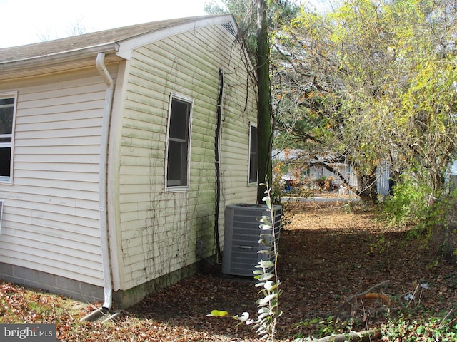 view of side of property featuring central AC