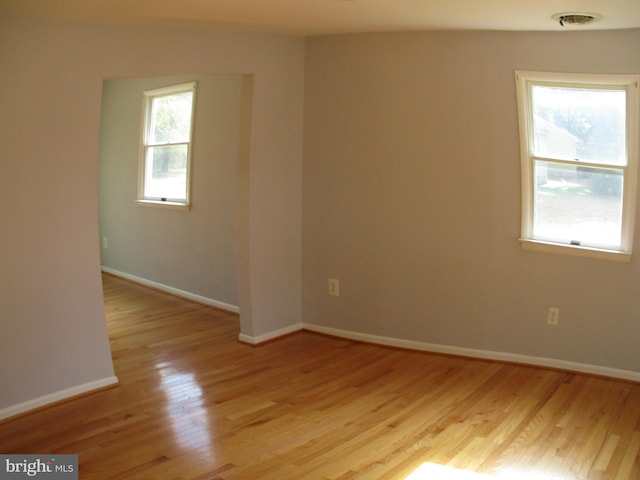 empty room with light hardwood / wood-style flooring