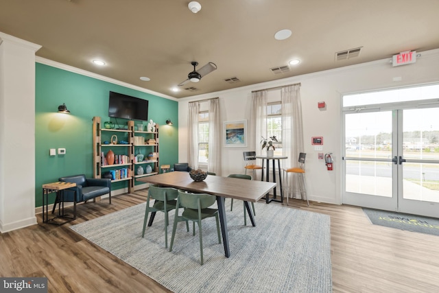 dining room with wood-type flooring, french doors, ceiling fan, and ornamental molding