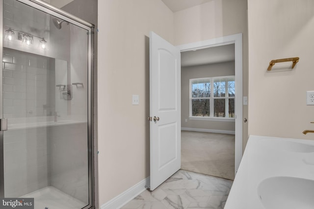 bathroom featuring an enclosed shower and sink