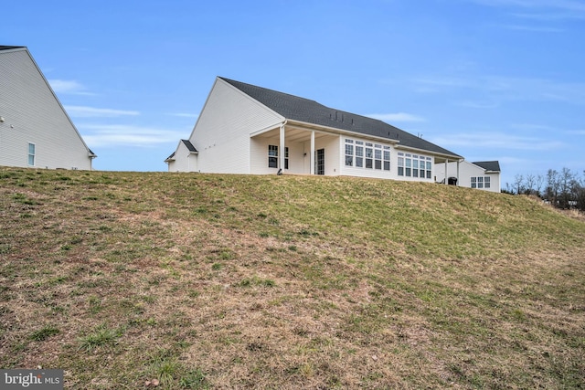 back of house with a lawn