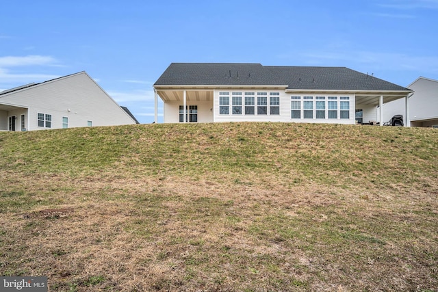 rear view of house with a lawn