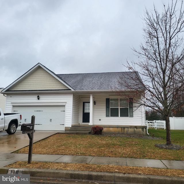 view of front of house with a front yard and a garage