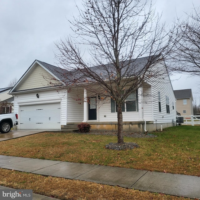 view of front of home with central AC unit, a garage, and a front lawn