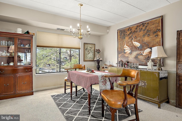 carpeted dining space with a textured ceiling and an inviting chandelier