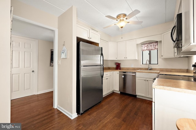 kitchen with white cabinets, sink, ceiling fan, dark hardwood / wood-style flooring, and stainless steel appliances