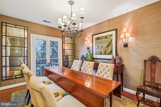 dining area featuring a notable chandelier and wood-type flooring