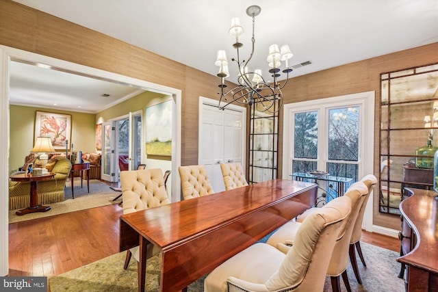 dining room featuring hardwood / wood-style floors and an inviting chandelier