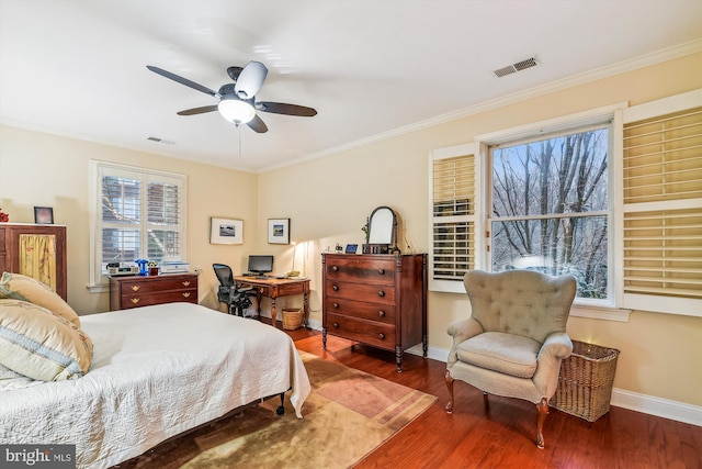 bedroom featuring hardwood / wood-style floors, ceiling fan, and crown molding