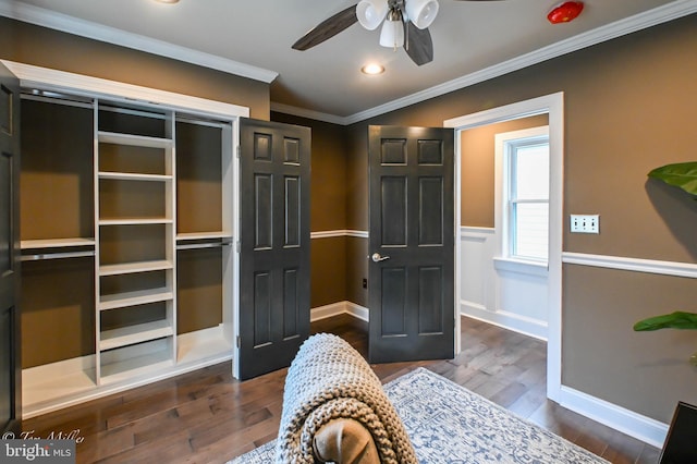 bedroom with ceiling fan, dark hardwood / wood-style floors, and ornamental molding