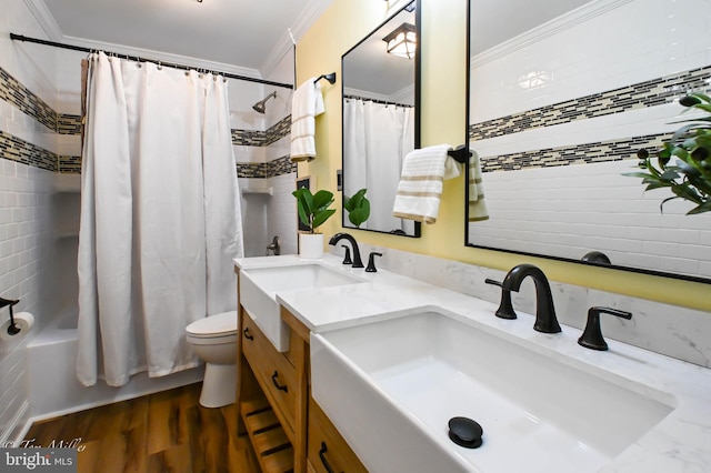 full bathroom with vanity, shower / tub combo with curtain, crown molding, wood-type flooring, and toilet