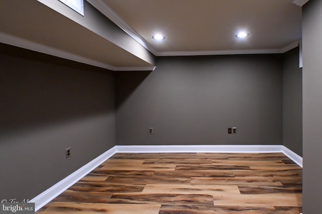 basement featuring crown molding and hardwood / wood-style floors