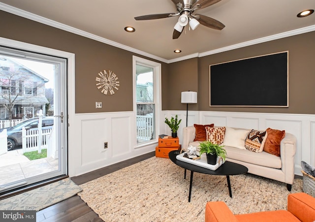 living room featuring ceiling fan, dark hardwood / wood-style flooring, and crown molding