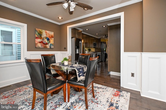 dining room with a wealth of natural light, ceiling fan, dark wood-type flooring, and ornamental molding