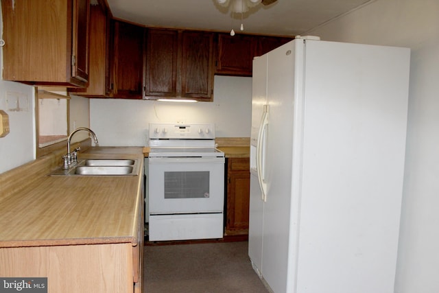 kitchen featuring white appliances and sink