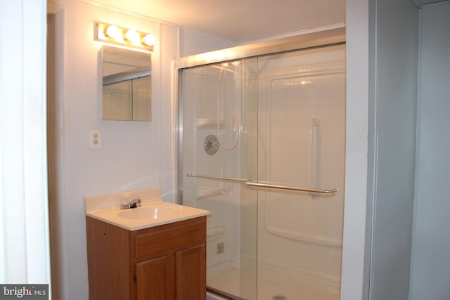 bathroom featuring vanity and an enclosed shower