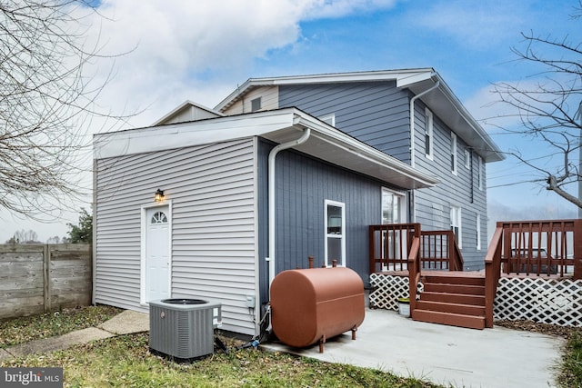 rear view of property with central AC and a deck