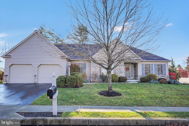 ranch-style house featuring a front lawn and a garage