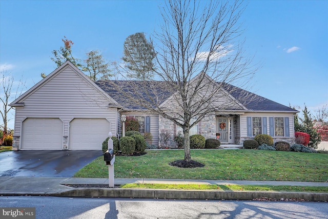 single story home with a front yard and a garage