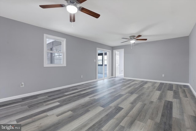 unfurnished room featuring ceiling fan and dark hardwood / wood-style flooring