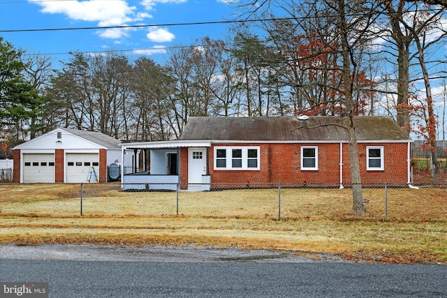 view of front of home featuring a porch, a garage, an outdoor structure, and a front lawn