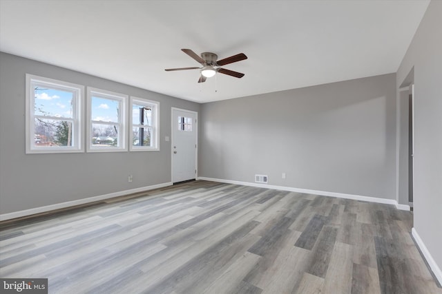 spare room featuring light wood-type flooring and ceiling fan