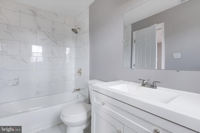 full bathroom featuring vanity, tiled shower / bath combo, and toilet