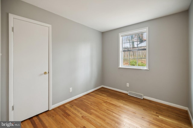 spare room with light hardwood / wood-style flooring