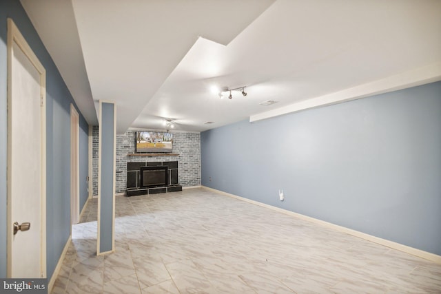 unfurnished living room featuring brick wall and a brick fireplace