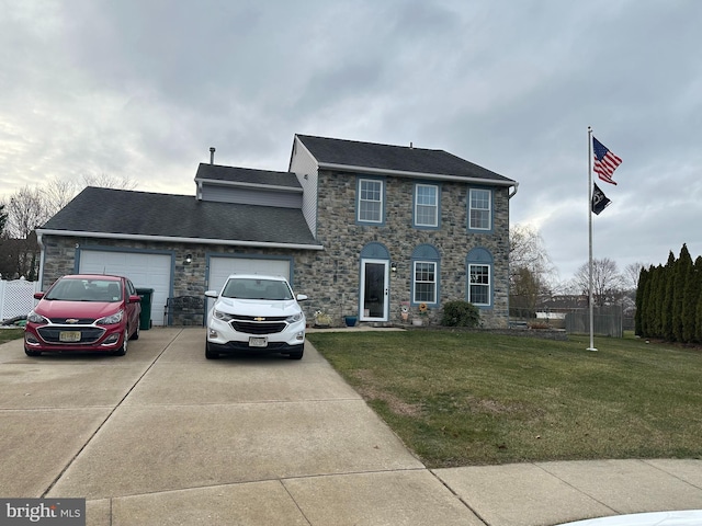 colonial house featuring a garage and a front lawn