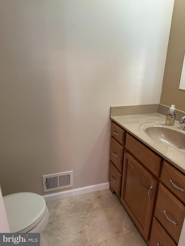 bathroom featuring vanity and toilet