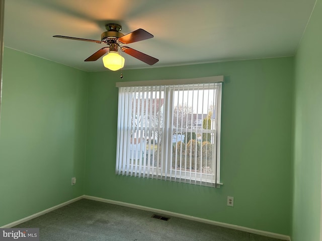 carpeted empty room featuring ceiling fan