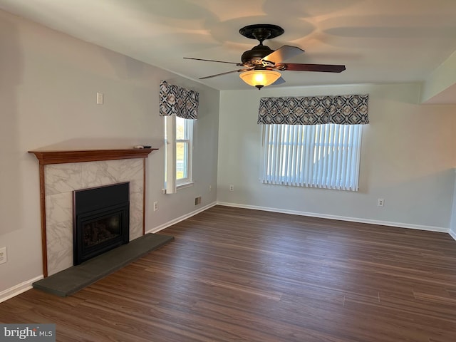 unfurnished living room with dark hardwood / wood-style floors and ceiling fan