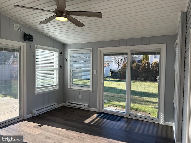 unfurnished sunroom featuring ceiling fan, lofted ceiling, and a baseboard heating unit