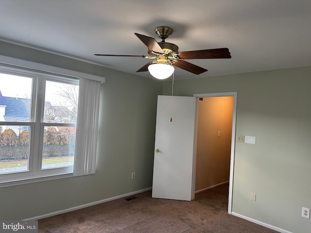 unfurnished bedroom with ceiling fan and carpet floors