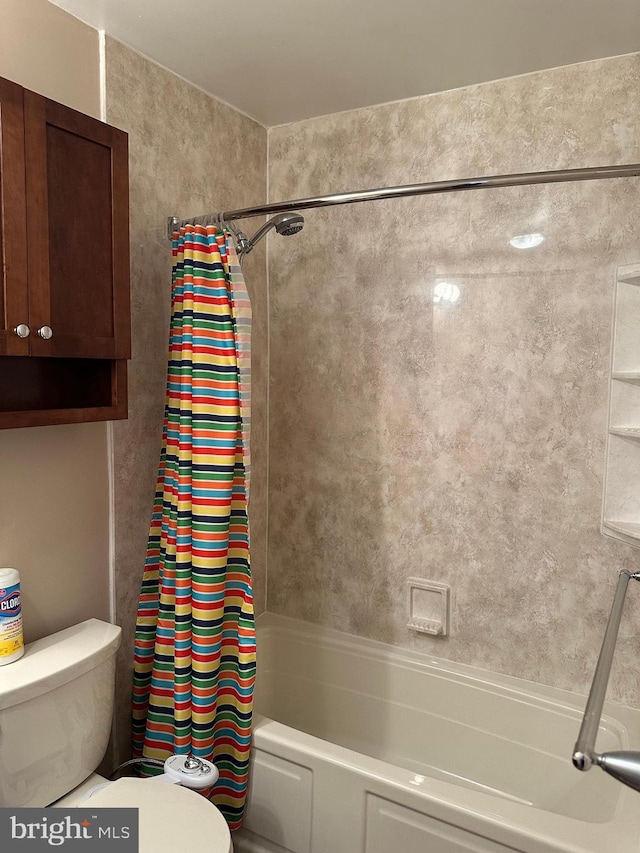 bathroom featuring shower / bath combo and toilet