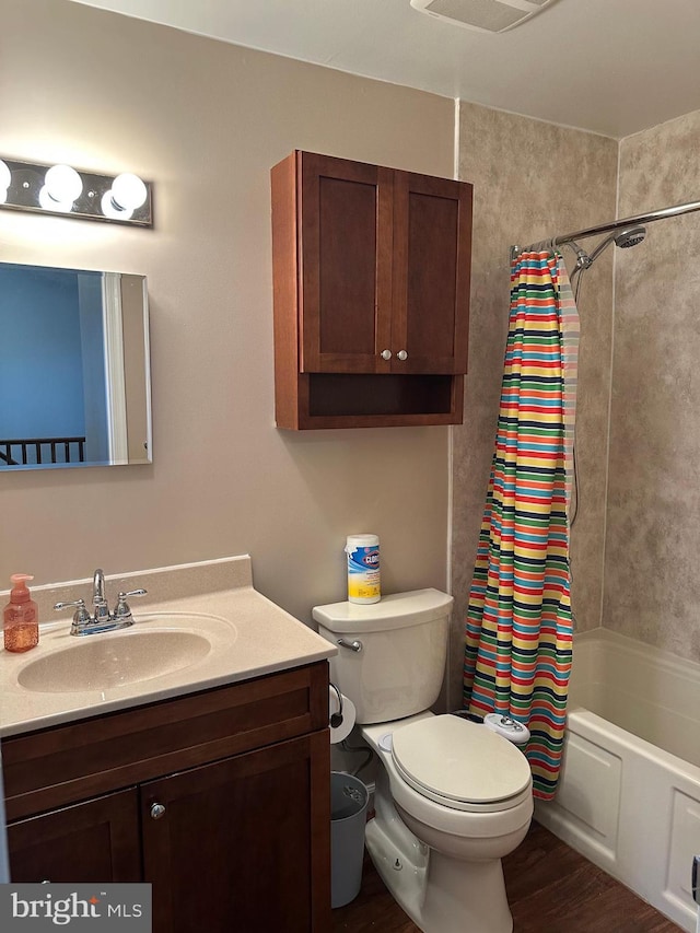 full bathroom with vanity, shower / bath combo, and toilet