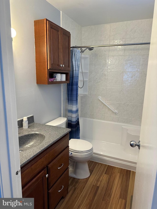 bathroom featuring hardwood / wood-style flooring, vanity, toilet, and a shower with curtain